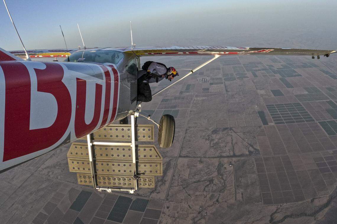 Pilot Andy Farrington is seen exiting the silver plane during during a skydiving plane swap on April 24, 2022, over Arizona. The stunt was half successful with Luke Aikins completing his swap and landing the plane while Farrington was unable to enter the other plane and parachuted to safety.