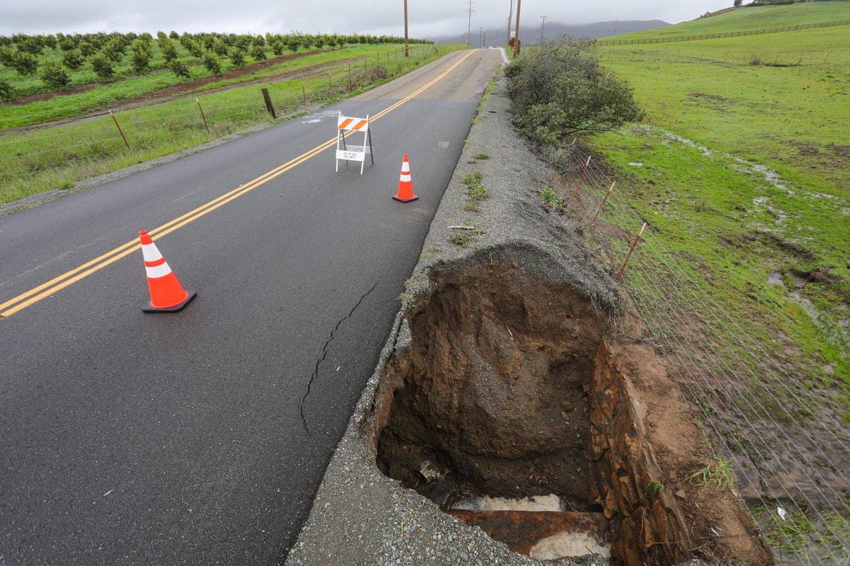 Orcutt Road is closed in both directions a mile north of Righetti Road due to undermined pavement as water flowed over a 1930s era wall and flowed under road seen Sunday Jan 15, 2023.