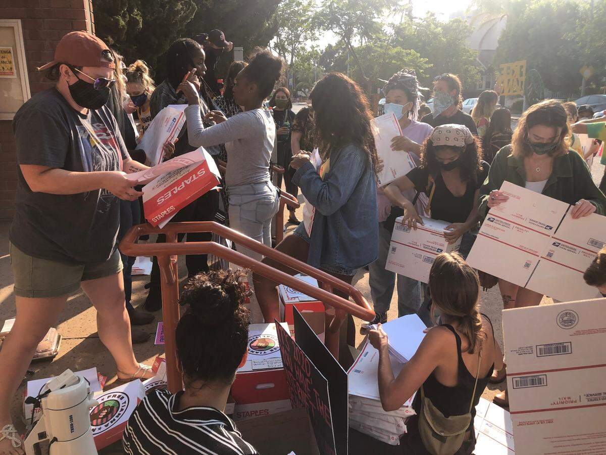 Several dozen supporters of local Black Lives Matter organizers arrive at the San Luis Obispo Superior Courthouse at about 5:15 p.m. Tuesday, Sept. 1, 2020, to package documents of roughly 500,000 signatures to mail to the District Attorney’s Office.