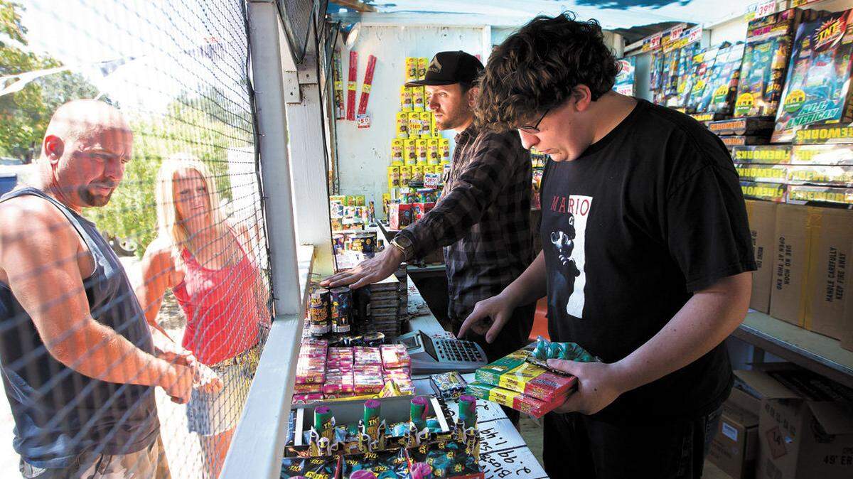 People buy fireworks at a stand in Templeton in 2012.