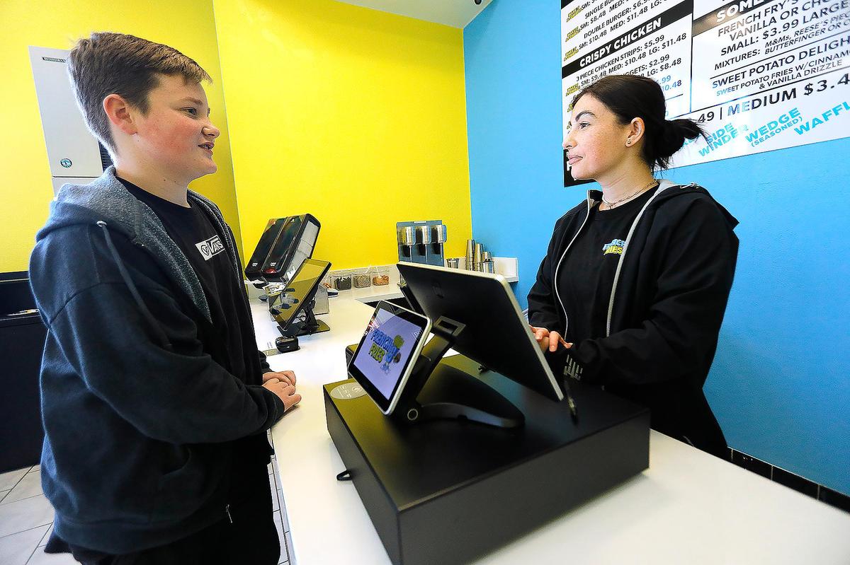 Shane Chew, 13, of Arroyo Grande was the first customer of the day at French Fries USA in Arroyo Grande on Feb. 1, 2023. He ordered chicken strips and fries.