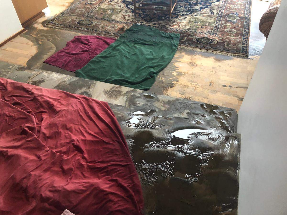 Mud and water flood the floors of Cambria resident Dianne Tappey’s hom on Thursday, Jan. 28, 2021. Storm debris blocked a public drain in the 2400 block of Sherwood Drive in Cambria, resulting in flooding that sent water and mud into Tappey’s house and several other homes.