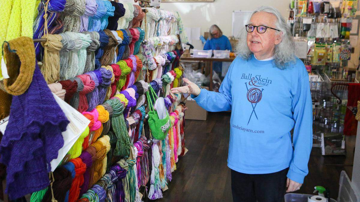 Oz Barron, foreground, and Kris Gregson, are taking new approaches to help their Cambria yarn shop, Ball & Skein & More, survive the COVID-19 lockdown. Supply chain issues have included getting yarns from South America.