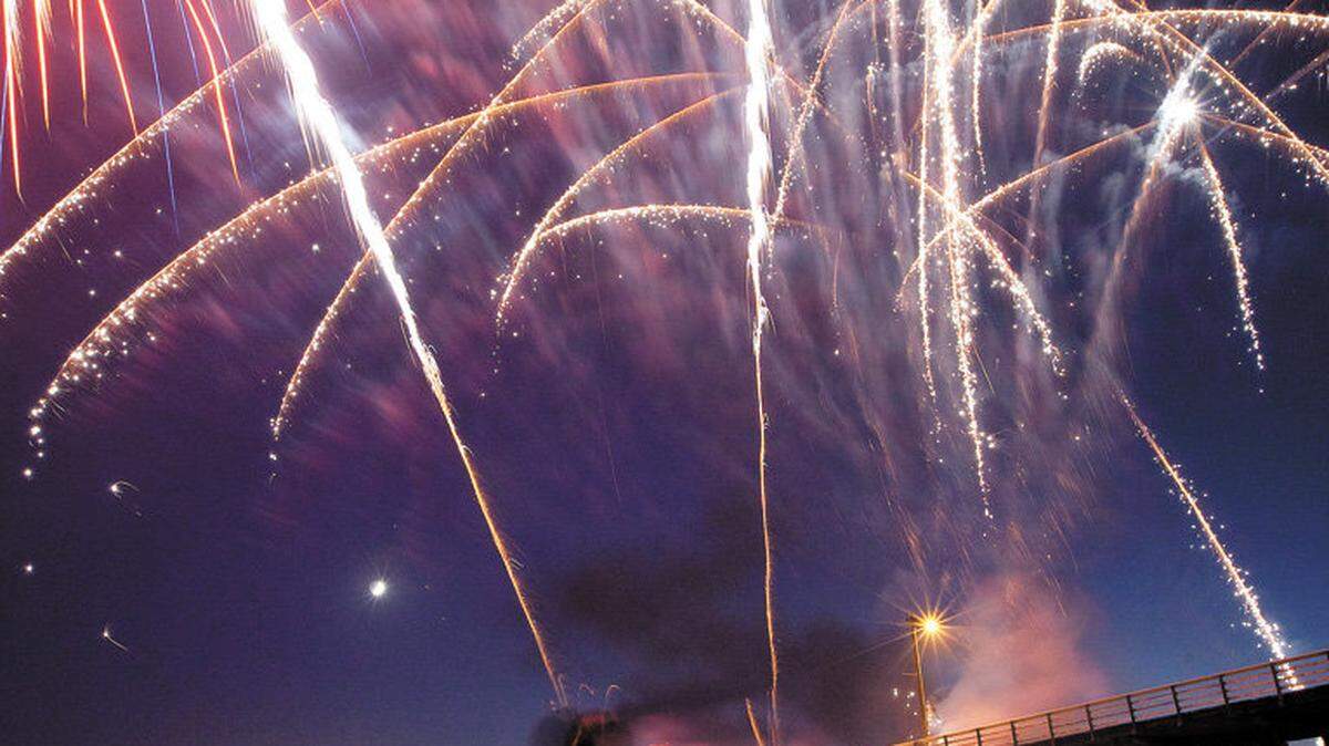 Danita Ross of Grover Beach watches the fireworks at the Pismo Beach Pier in 2011.