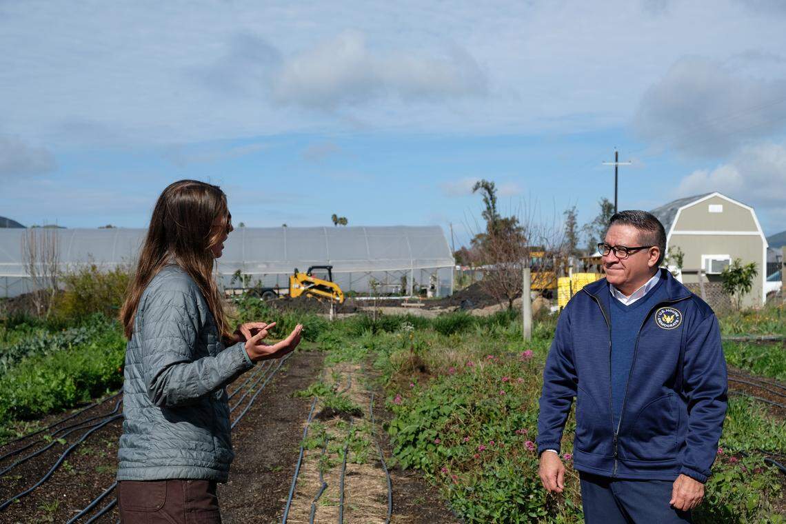 Farm operations coordinator Kate DiTrani explains the mission of City Farm SLO to Rep. Salud Carbajal, who paid a visit to the site on Feb. 18, 2026, as part of his Central Coast affordability tour.