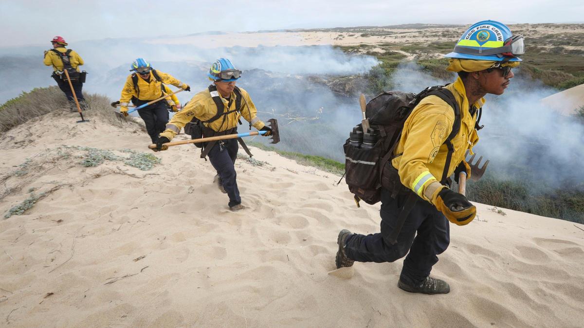 Firefighters battle a stubborn brush fire West of Oso Flaco Lake in the Oceano Dunes on April 21, 2025