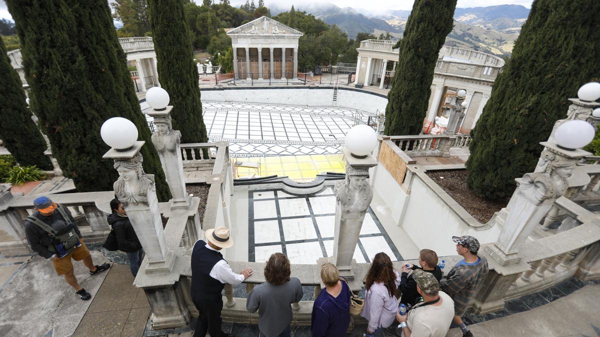 Visitors learn about the repairs to the Neptune Pool during a tour of Hearst Castle in May.