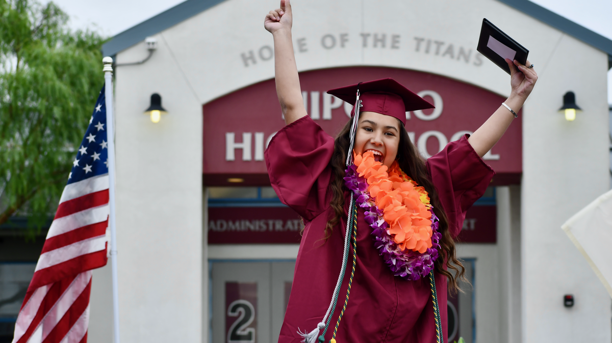 Julissa Ramirez raises her arms in celebration during Nipomo High School’s Class of 2020 graduation ceremony.