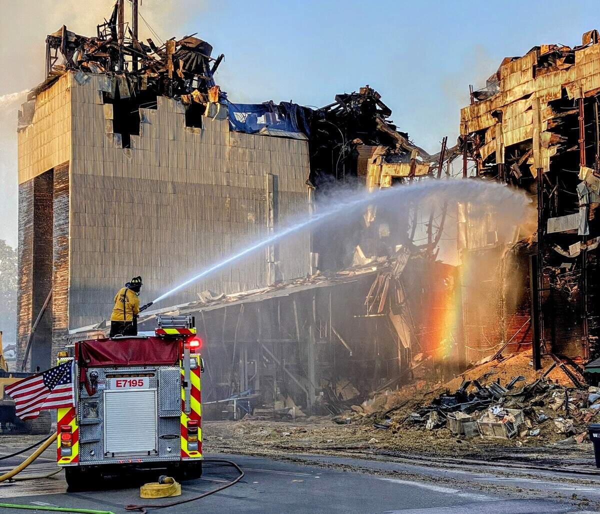 Templeton Fire personnel spray water on the remains of the Feed & Grain building after the July 4, 2025, fire in downtown Templeton. The response continued after the flames were contained as crews worked to secure the site.