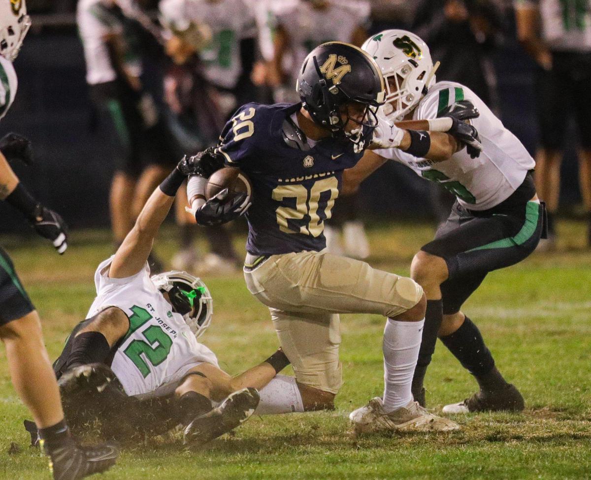 Jayden Nozil is tackled by two St. Joseph defenders. Mission Prep fell to St. Joseph 49-21 on Oct. 28, 2022, in the last game of the regular season, giving the Knights the Mountain League football championship.