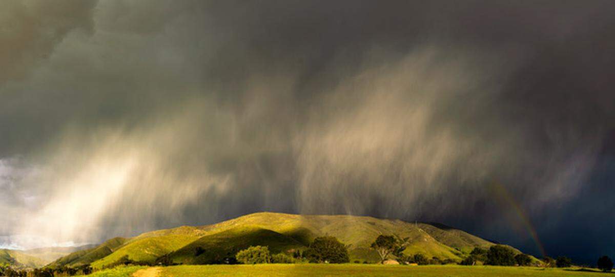 The view from Terrace Hill, where it began hailing and raining in the early evening, forming a rainbow over the hillside.