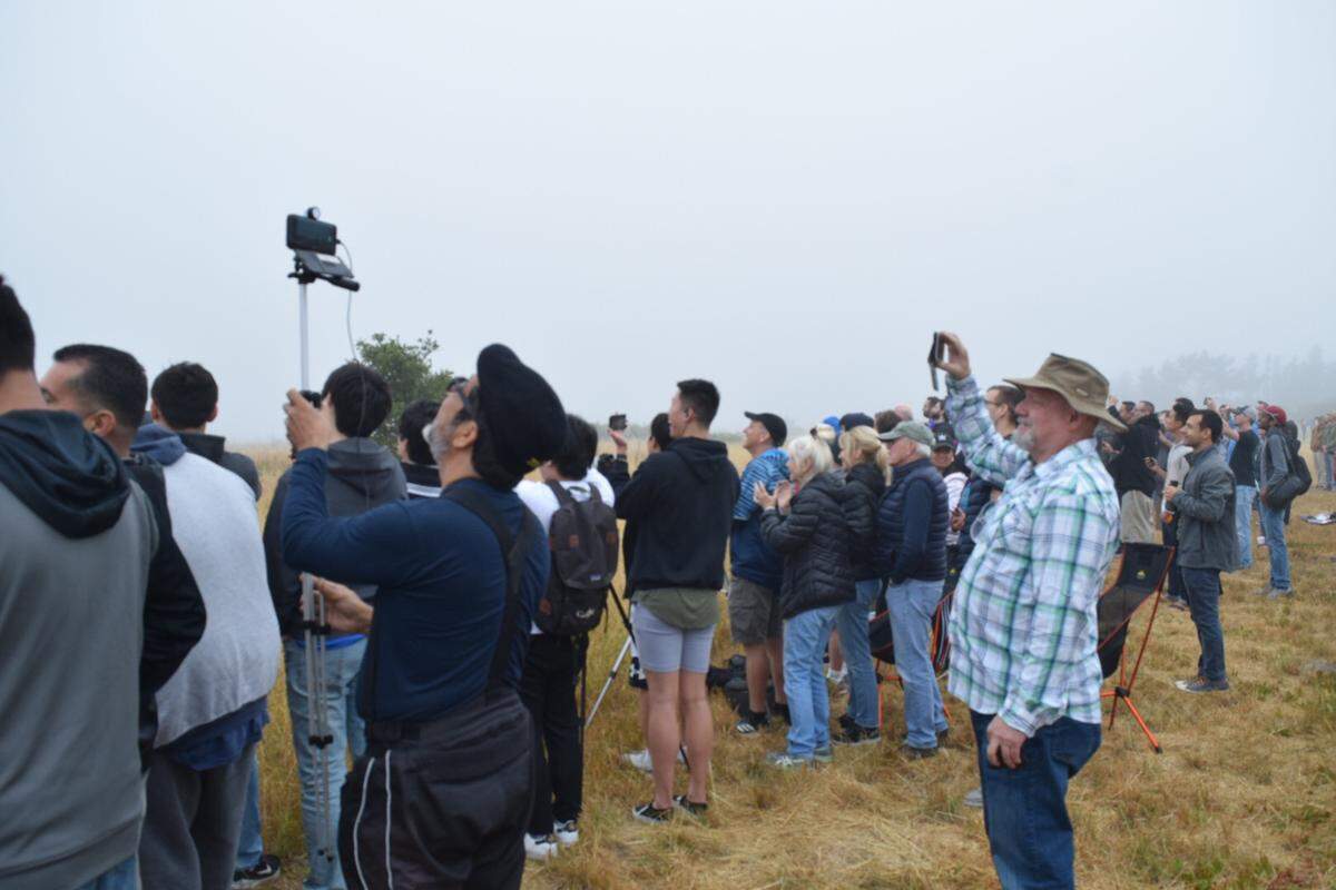 Spectators at Hawks Point on Vandenberg Air Force Base try to catch a glimpse of the SpaceX rocket launch through the fog on Wednesday morning.