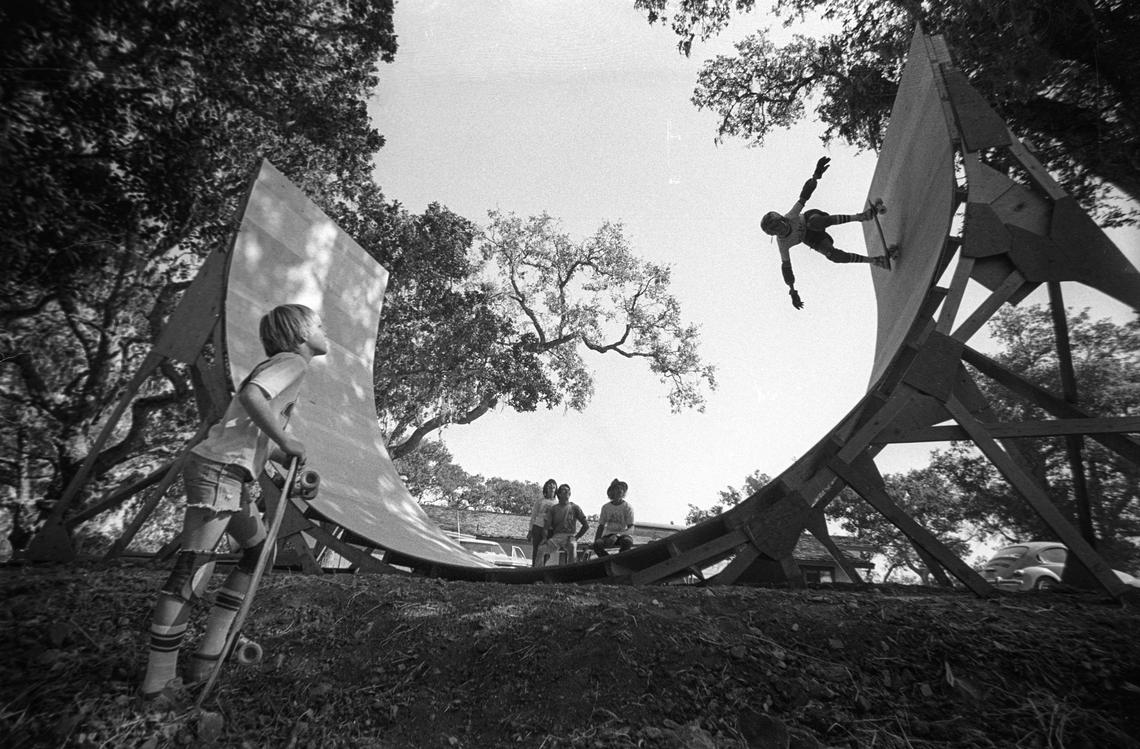 David Crother rides his famly's skateboard ramp while his brother, Kirk, left, waits his turn. Deanna and Loren Crother and Bob Shaw watch in the background.