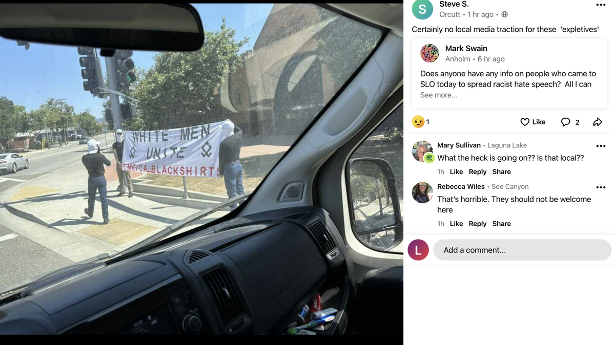 Masked men hold up a “White Men Unite” sign in front of the San Luis Obispo Fire Department’s Station No. 1 on Saturday, July 22, 2023.