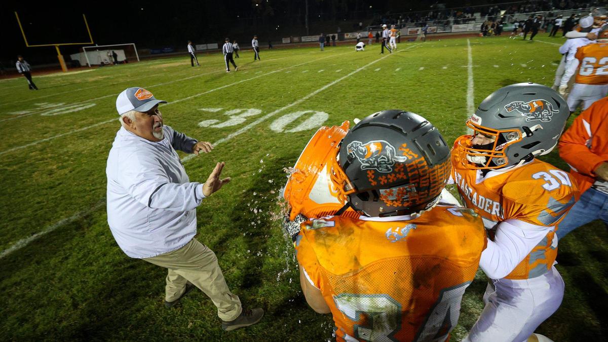 Head coach Victor Cooper is doused with water by Trey Cooks and Austin Smith. Atascadero High School beat Pioneer Valley 27-13 to win the Division V, 2022 CIF Central Section Football Championships Nov. 25, 2022.