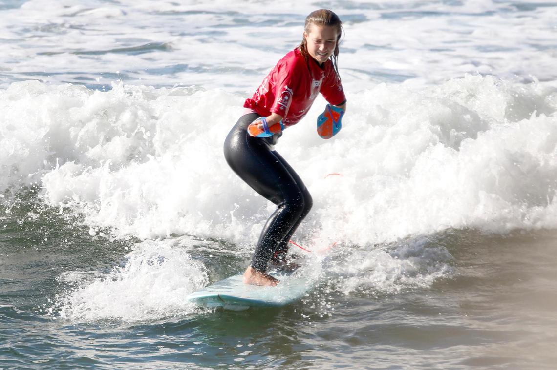 Olivia Stone, Team USA, surfs next to Pismo Pier in the Round One, Stand 1 women’s competition. The world’s largest para surfing competition takes place in Pismo Beach through Dec. 11.