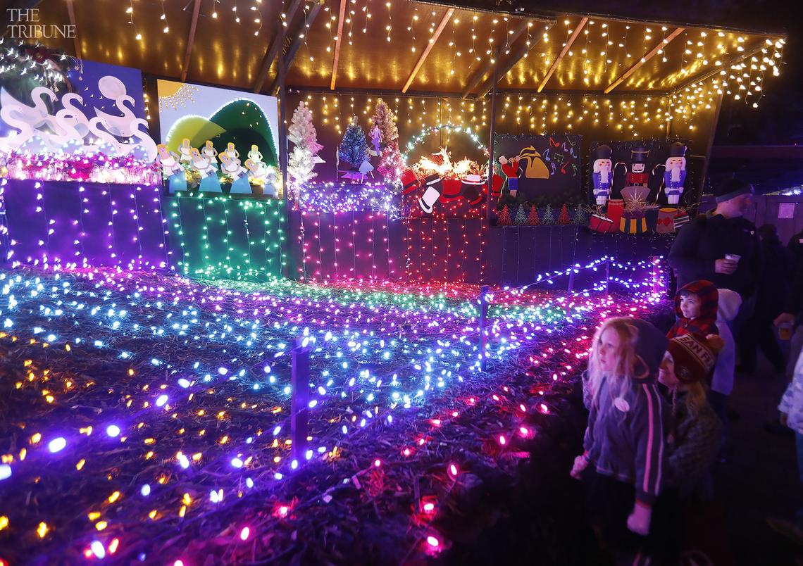 Patricia Kerr, 6, of Santa Barbara, front, and other children watch the 12 Days of Christmas display at the Cambria Christmas Market. The popular San Luis Obispo County holiday event will reopen to the public in November 2022.