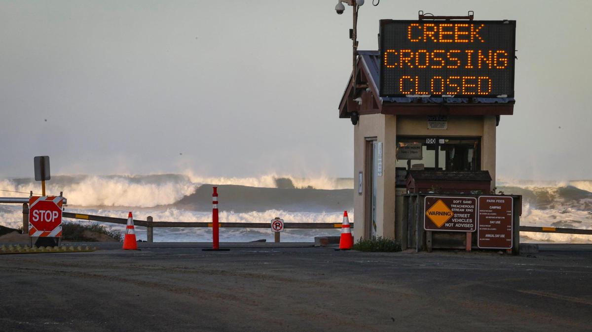 Waves crash at Oceano Dunes State Vehicular Recreation Area. Entry sign on Pier Avenue warned that the Arroyo Grande Creek crossing was closed during high tide. There was a 6.8-foot King Tide on the morning of Dec. 13, 2024 that got a little extra push from a series of incoming storms.