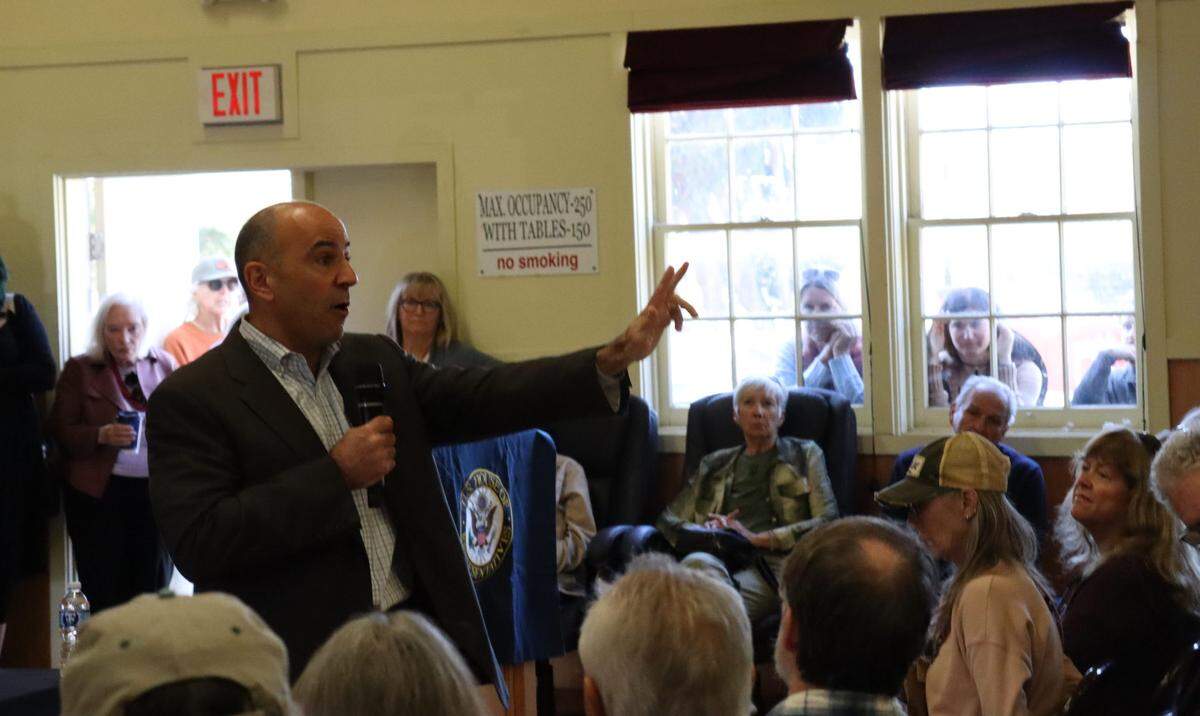 A packed house, including people watching through the windows, listen as Congressman Jimmy Panetta, D-Santa Cruz, gives a town hall speech at the Cambria Veterans Hall on March 21, 2025, to address his constituents questions and concerns about what is going on in Congress during the first months of the Trump administration.