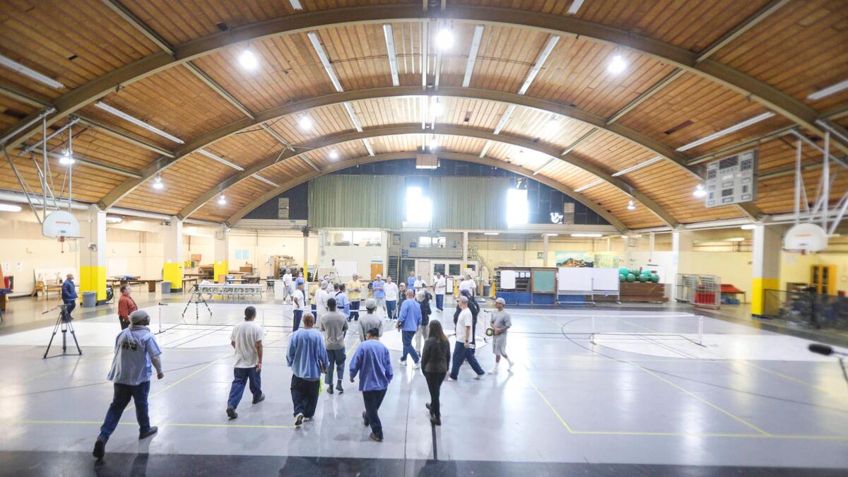 Pickleball coach Roger BelAir visited the California Men’s Colony in San Luis Obispo on Nov. 12, 2024, to teach the game to inmates. Hollywood filmmaker Daniel Ostroff was producing the documentary “Pickleball in Prison,” and a film crew was recording how the sport can break down barriers and provide positive interactions between inmates and staff.