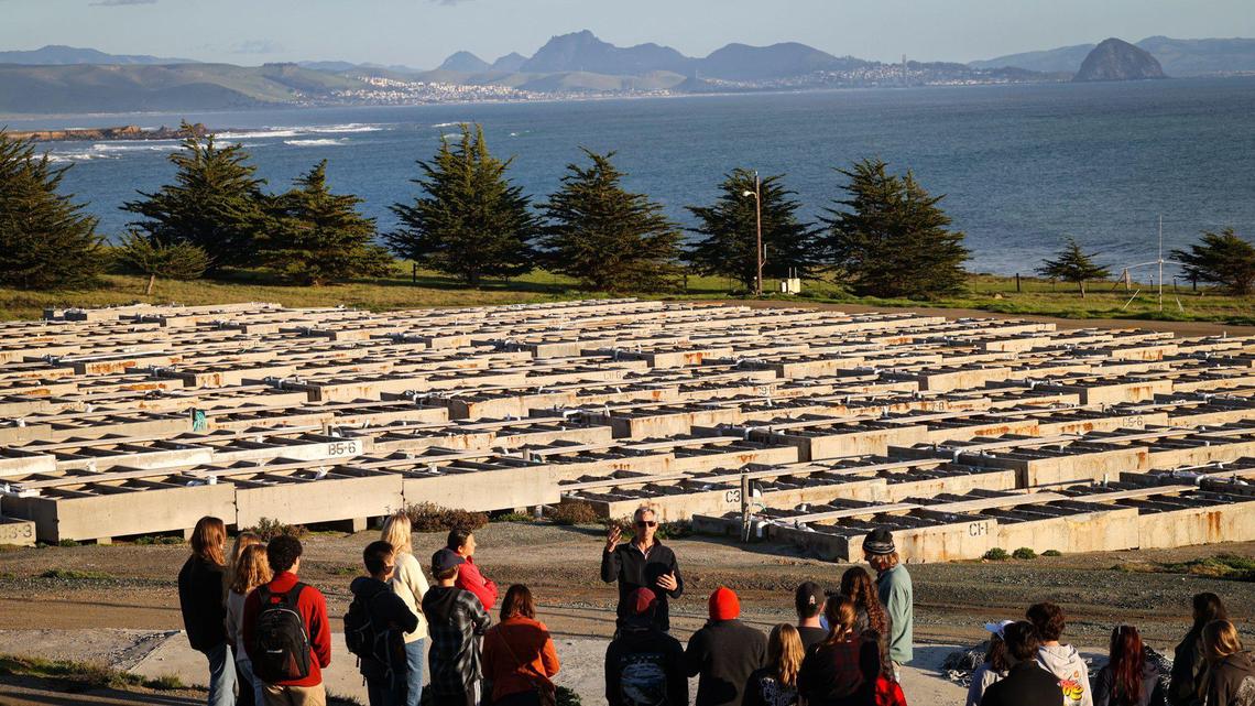Benjamin Ruttenberg, chief science officer of Harmony Coast Aquaculture Institute, leads a group of Cal Poly science students on a tour of the former abalone farm north near Cayucos on Feb. 6, 2023. The farm’s concrete tanks, which have been dry and unused since the facility shut down in 2020, could become a center for sustainable aquaculture.