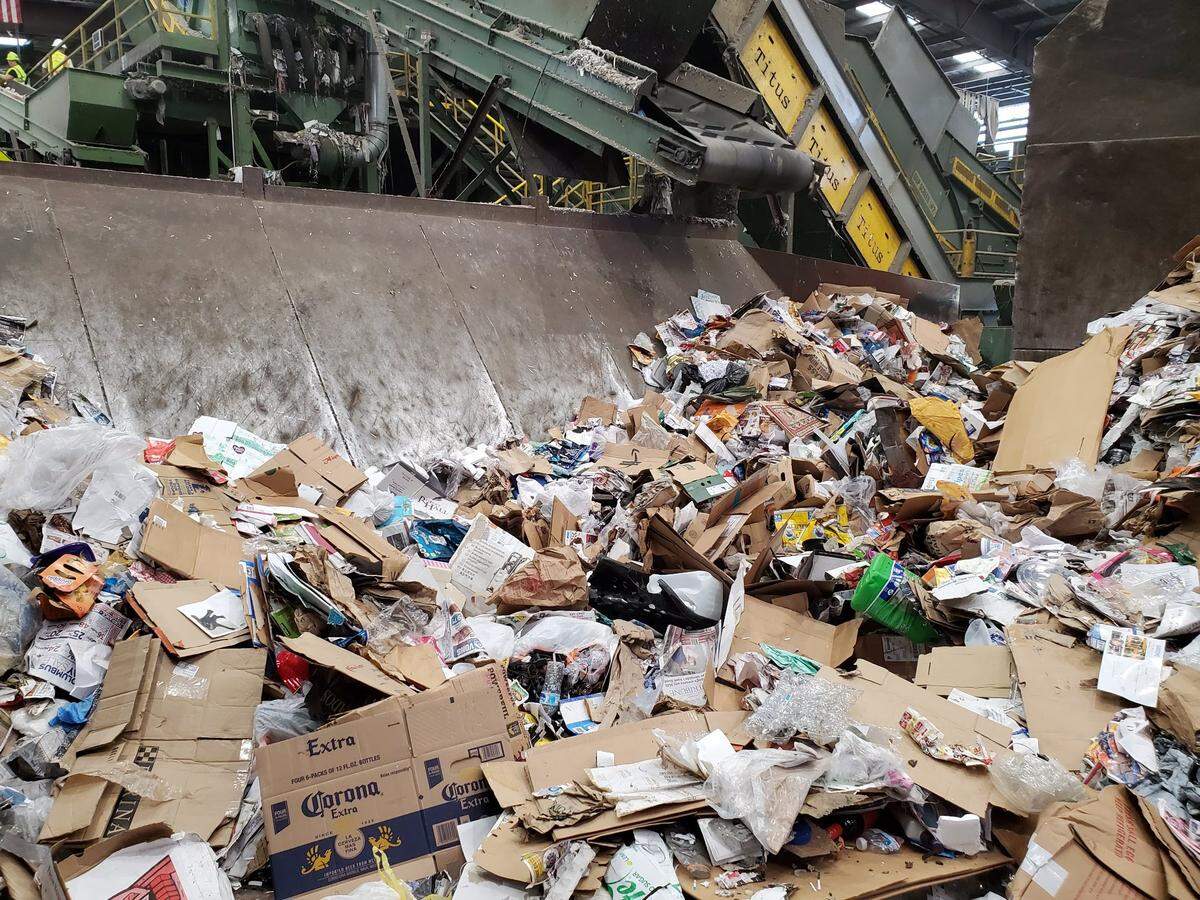 Material from single-stream recycling is dumped on the tipping floor and loaded into the machine that processes material at Waste Connections’ Cold Canyon Material Recovery Facility in SLO.