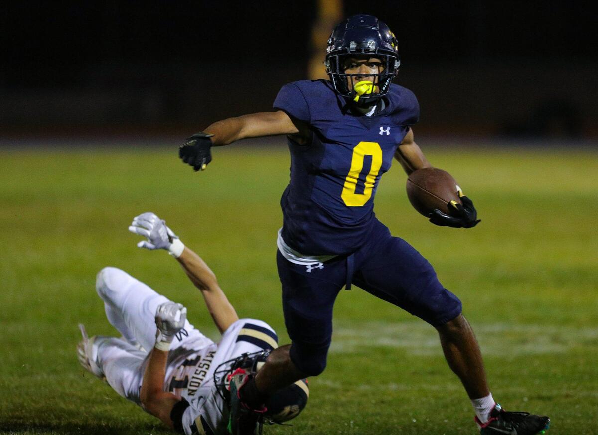 Caleb Clark evades a tackle by Luke Terry. Arroyo Grande beat Mission Prep 10-3 in a high school football game on Oct. 13, 2023.
