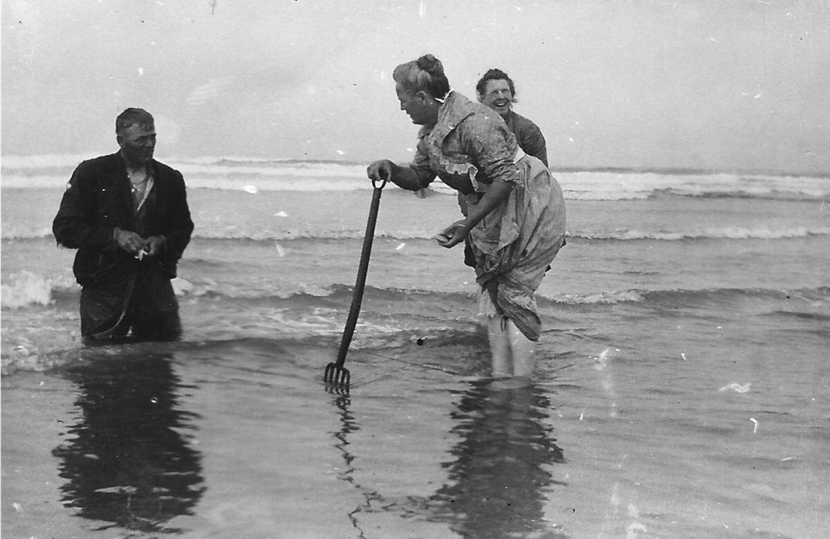 An undated photo shows people clamming in the surf line at Pismo Beach.