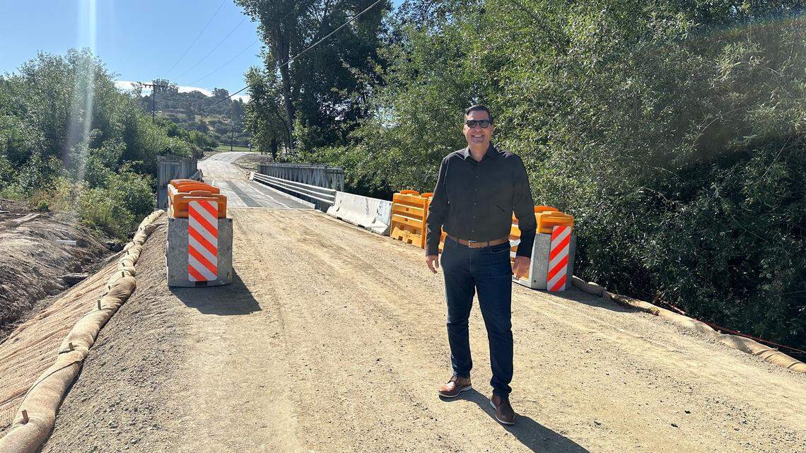 San Luis Obispo County Supervisor Jimmy Paulding poses with the completed temporary bridge at Cecchetti Road.