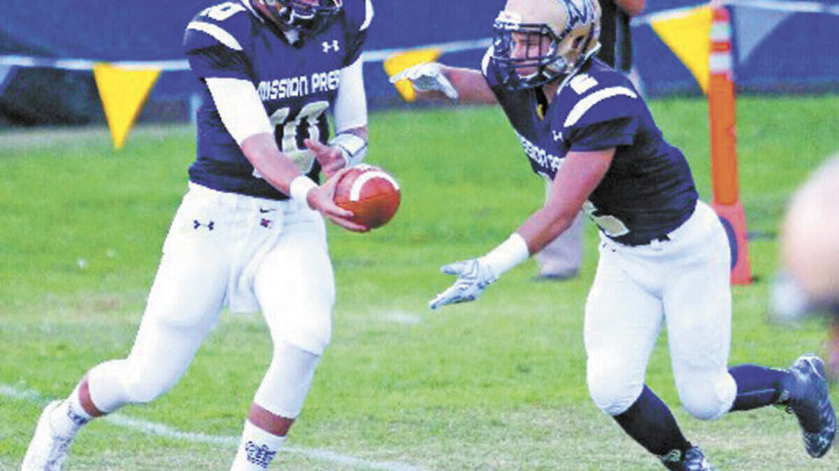 Mission Prep's Bryce Fledderman hands off to Brayden Corona in the first quarter of the first football game of the season against Rio Hondo. Mission Prep hosted Rio Hondo in the opening football game of their seasons.