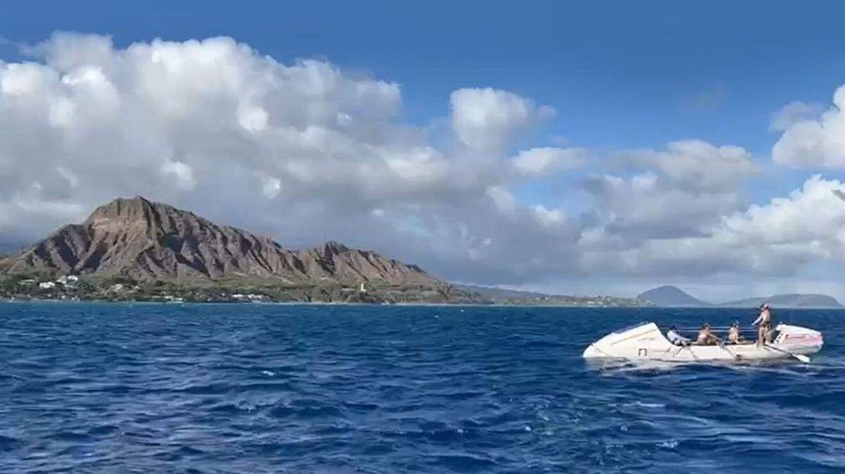 The Lat 35 crew rows past Diamondhead while on its way to finishing its record-setting journey from San Francisco to Hawaii.
