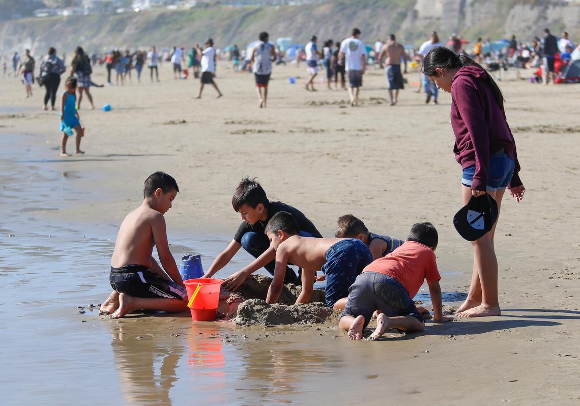 Family and children played along the water’s edge in Pismo Beach. The beaches in Pismo Beach and Avila Beach were fairly packed with visitors Saturday during Memorial Day weekend with the coronavirus pandemic still ongoing. Gov. Newsom allowed San Luis Obispo county to relax some of the coronavirus pandemic restrictions.