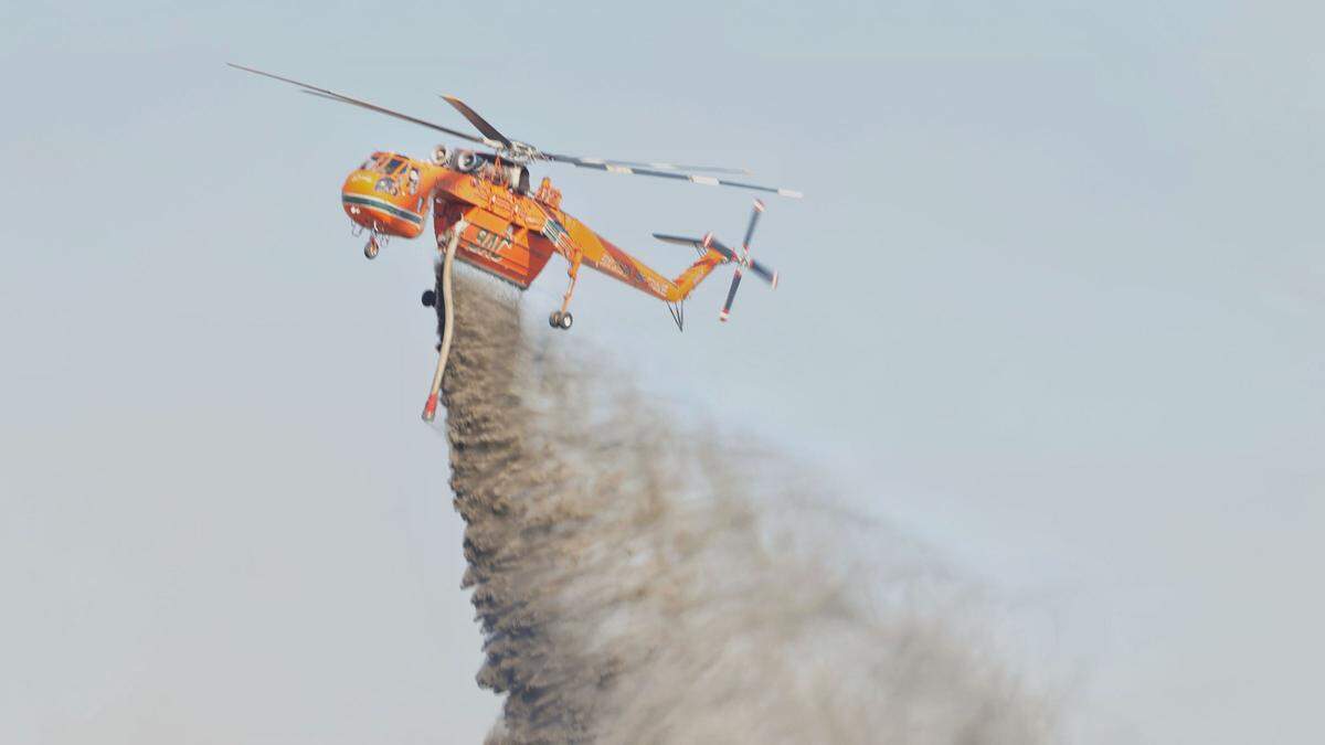 A helicopter dousing a fire in Nipomo on July 15, 2022.