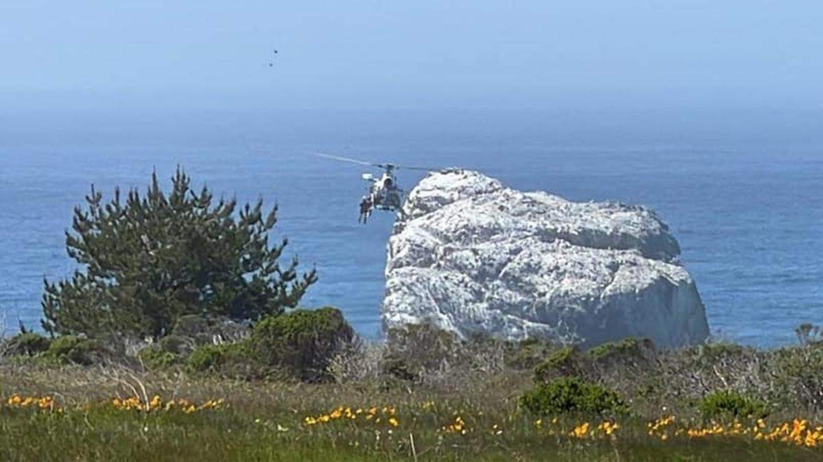 The CHP’s H-70 helicopter hovers over Sand Dollar Beach on Wednesday, April 6, 2022, while rescuing a person who had fallen on the rocks.