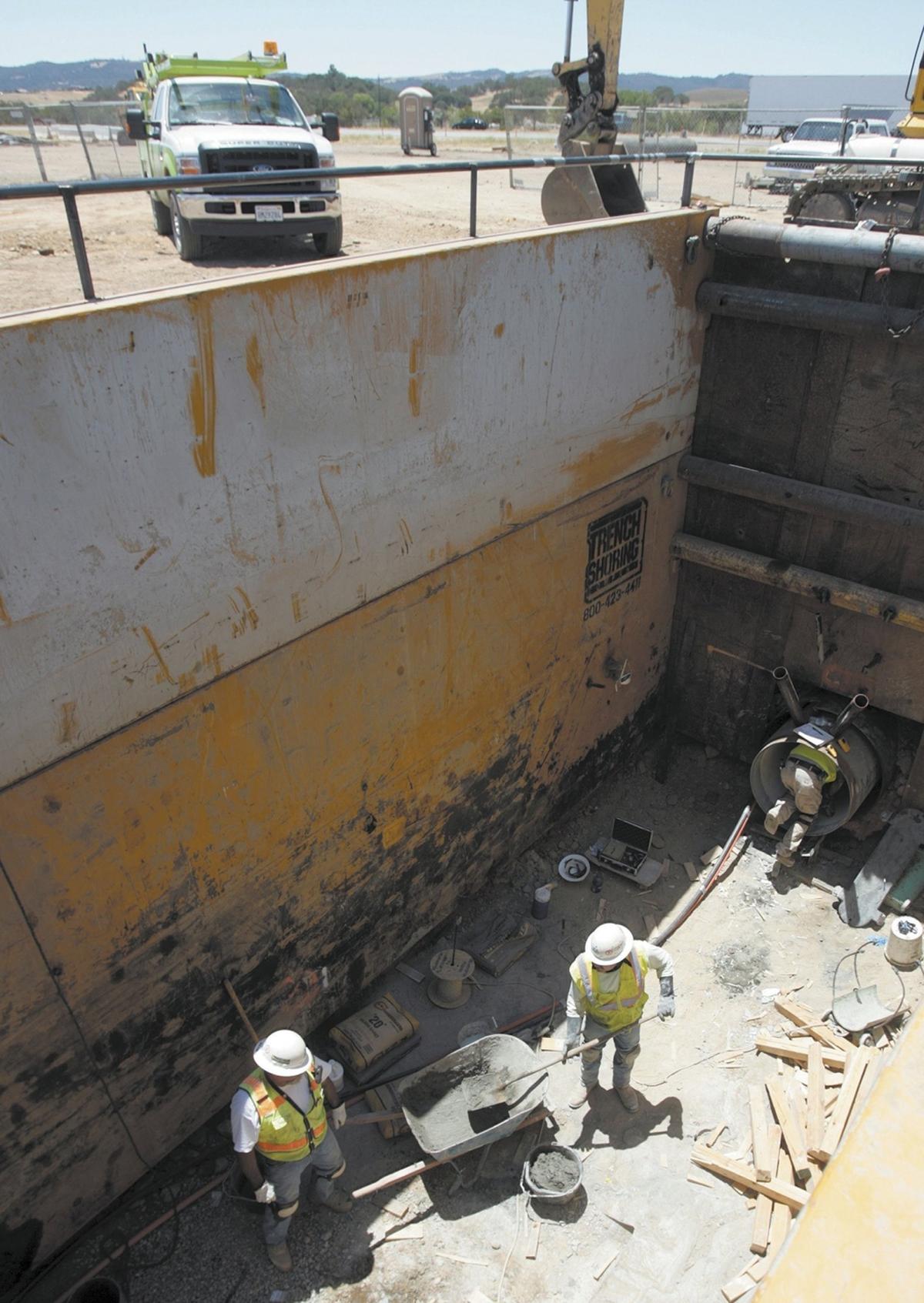 Workers with Teichert Construction mix grout used to seal the seams in the Nacimiento Pipeline where it crosses under Highway 101 at Wellsona Road. The pipe is 36 inches wide and will carry water south from Lake Nacimiento to communities from Paso Robles to San Luis Obispo.