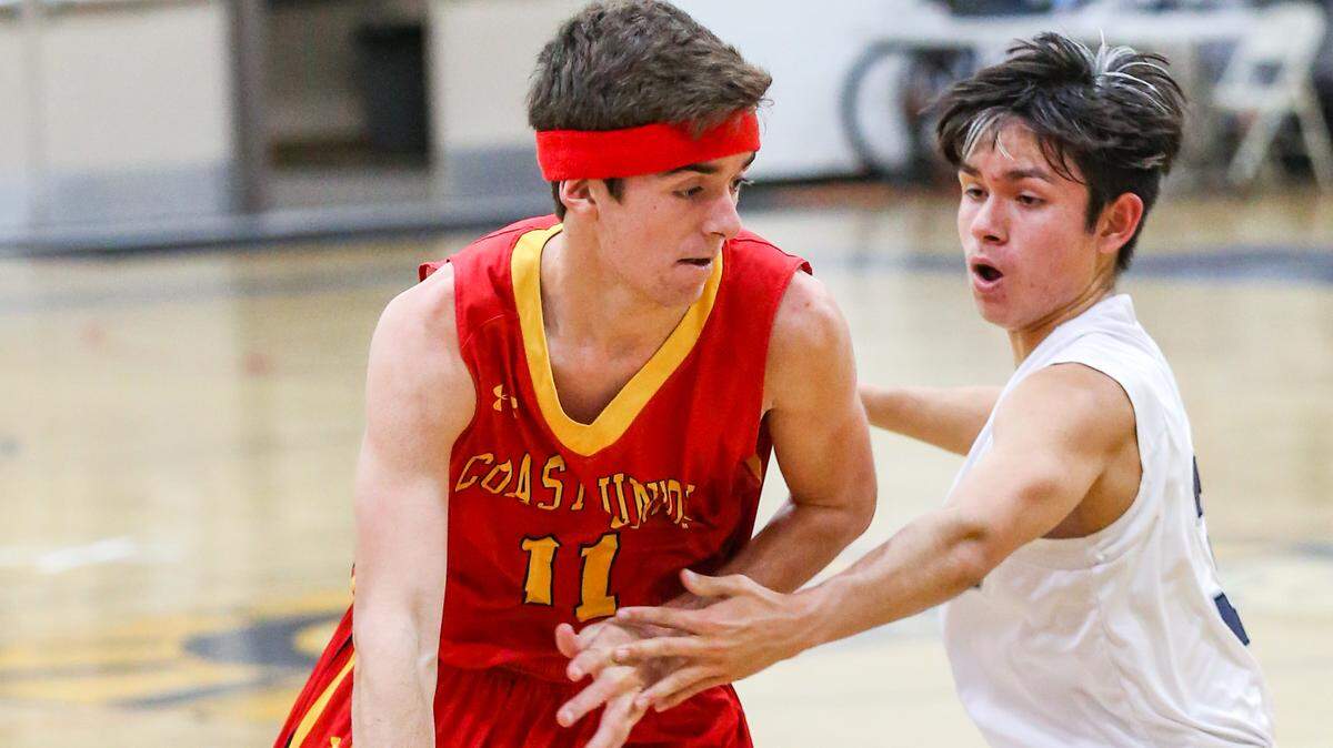 Coast Union High School junior Nate Markham led the team in scoring at 18.5 pionts per game and rebounding at 8.7 per game. Here he controls the ball against Orcutt Academy earlier this season.