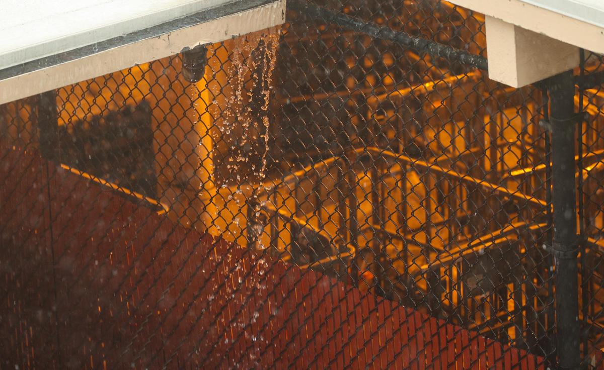 Rain runs off the post office roof in downtown San Luis Obispo, Dec. 23.