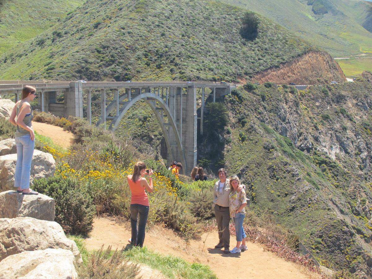 Tourists pose for photographs at Bixby Bridge in Big Sur, California.