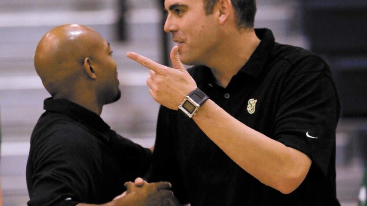 St. Joseph High coach Tom Mott, the former Mission Prep coach, shakes hands with Royals coach Terrance Harris, left, after the Knights’ 44-42 victory Wednesday at Mission Prep.