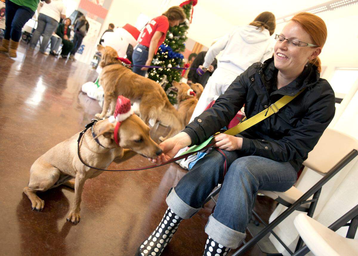Wood’s Humane Society held its annual Holiday Open House, Saturday, Dec. 1, 2012. Conny Liegl, San Luis Obispo, waited for a portrait with Santa Claus with her then 2-year-old mutt (as she called her) Leila.