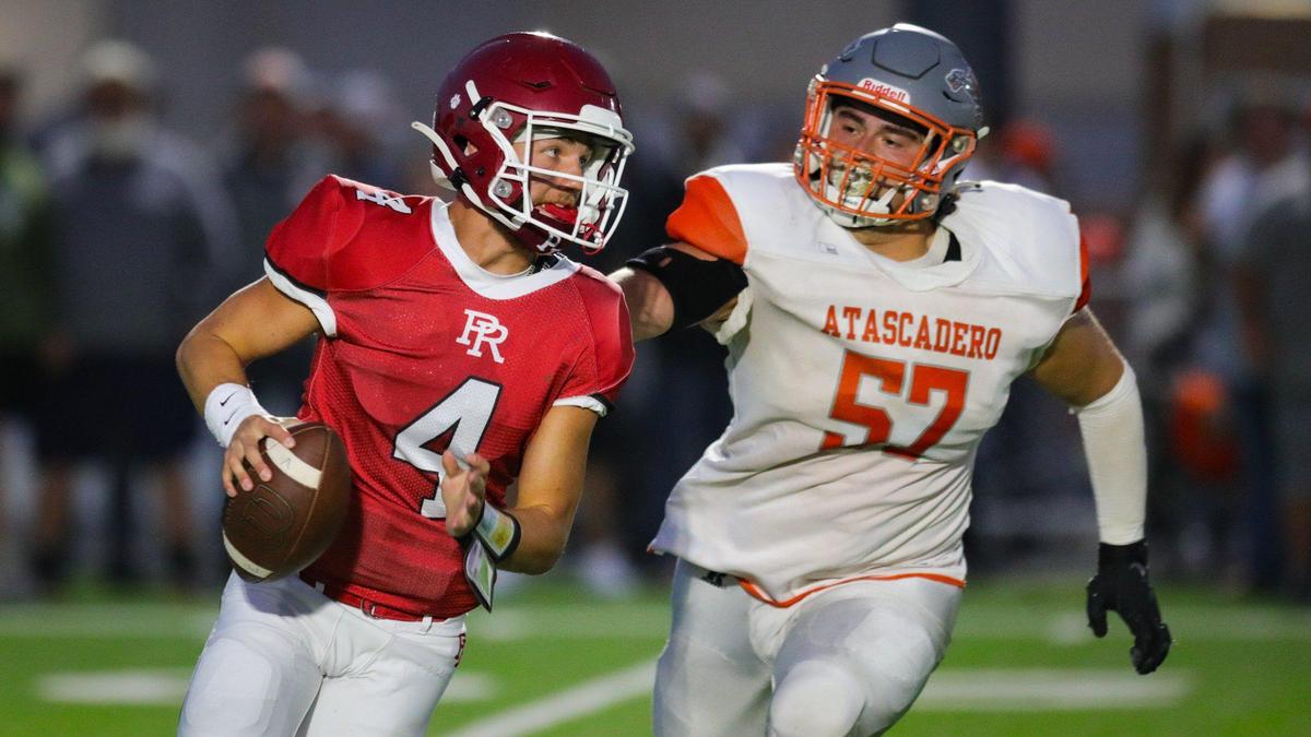 Hayden McKenna is pursued by Anthony Tejeda. Atascadero beat Paso Robles 28-14 at War Memorial Stadium on Sept., 1, 2023.