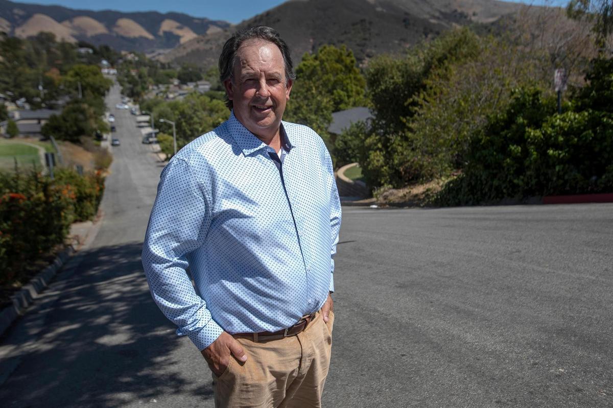 Brett Cross, vice president of Residents for Quality Neighborhoods, stands on McCollum Street near Cal Poly. Homes in neighborhoods in the areas close to campus are increasingly being bought up by investors who turn them into student rentals.