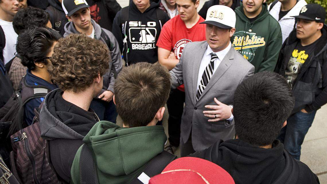 New San Luis Obispo High football coach Pat Johnston (white hat) meets with returning Tigers football players Wednesday after the school announced him as its coach.