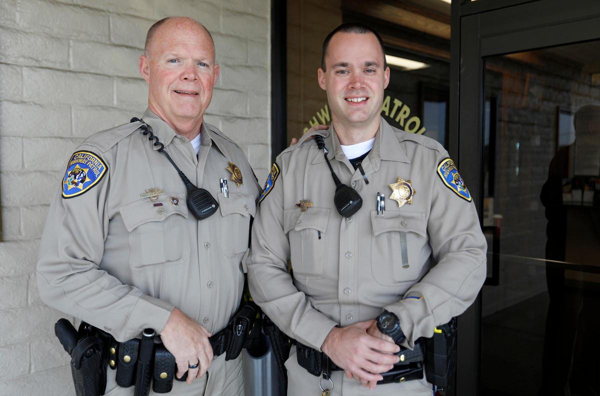CHP Officer Doug Villars standing next to his son, Cory Villars, in front of the Templeton CHP office. Cory Villars, a King City CHP officer, joined his father on patrol Thursday.