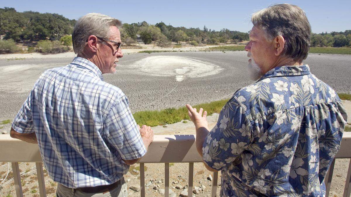Jon Trumbull, left, and Don Lynge are members of Friends of Atascadero Lake. The lake is nearly dry — only a birdbath-sized pond remains.