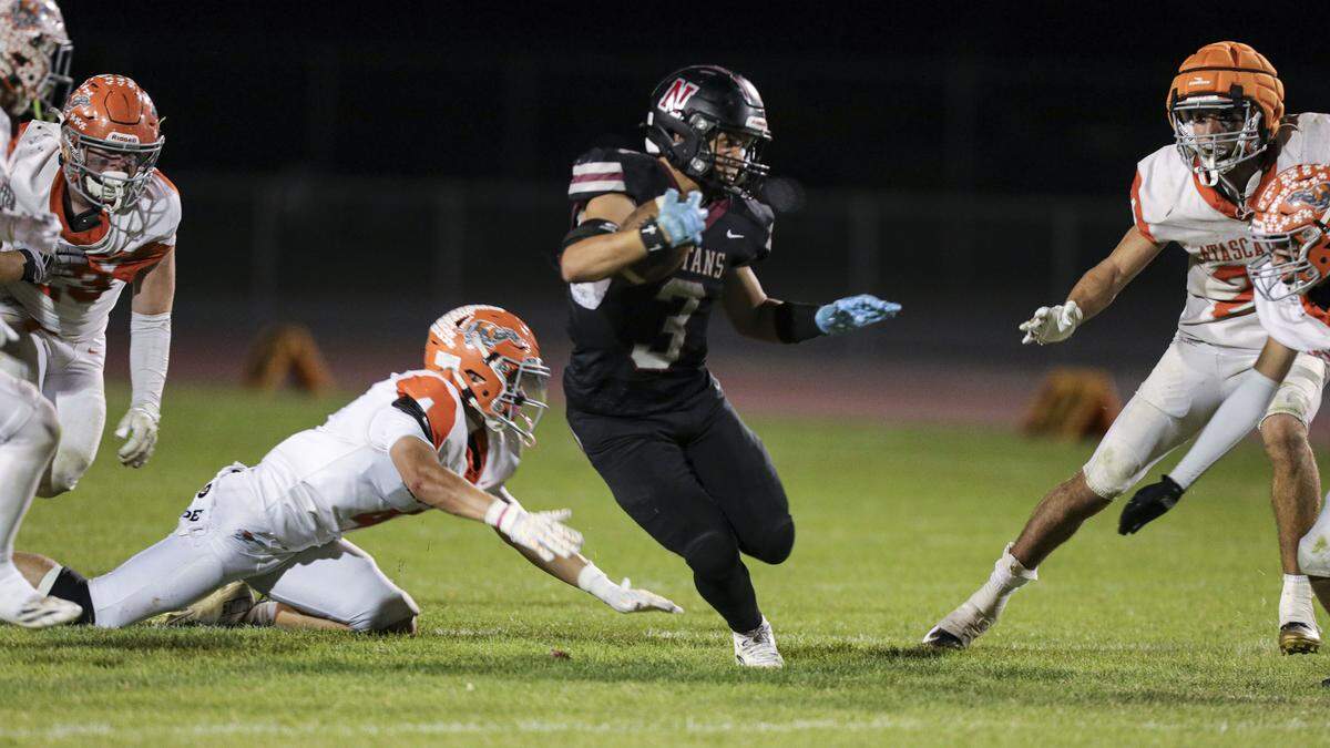 Nick Evans runs through an opening in the Greyhound line. Nipomo beat Atascadero 35-34 in a double-overtime playoff football game on Nov. 7, 2025.