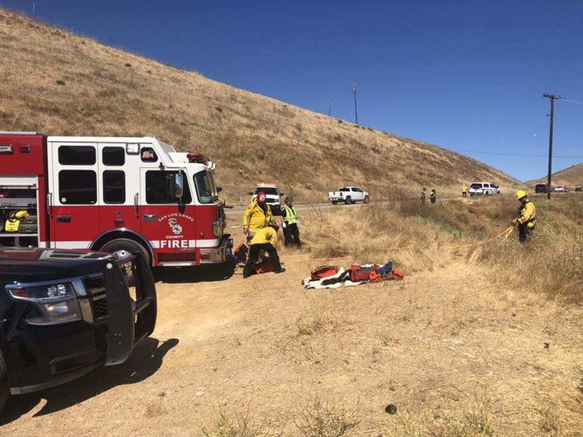 Cal Fire firefighters helped remove two people from the wreck of a Tesla that crashed about 200 feet down a hill on Highway 46 Thursday, July 4, 2024.