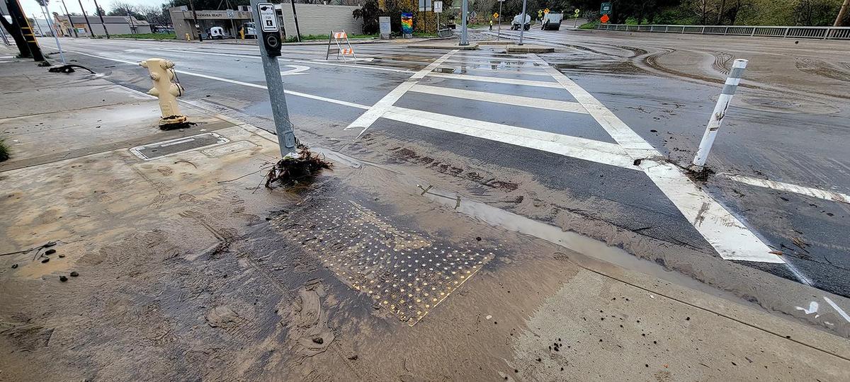 San Luis Obispo city crews worked to clear mud and debris from the intersection of Marsh and Higuera Streets on Tuesday morning, Jan. 10, 2023.