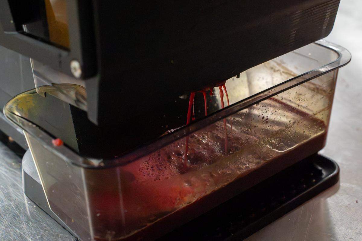 Appleade juice colored with beets filters through a juice press machine in the kitchen at CaliPaso in San Luis Obispo on Thursday, May 14, 2026. Just one or two beets can color a batch of around 100 bottles of juice.