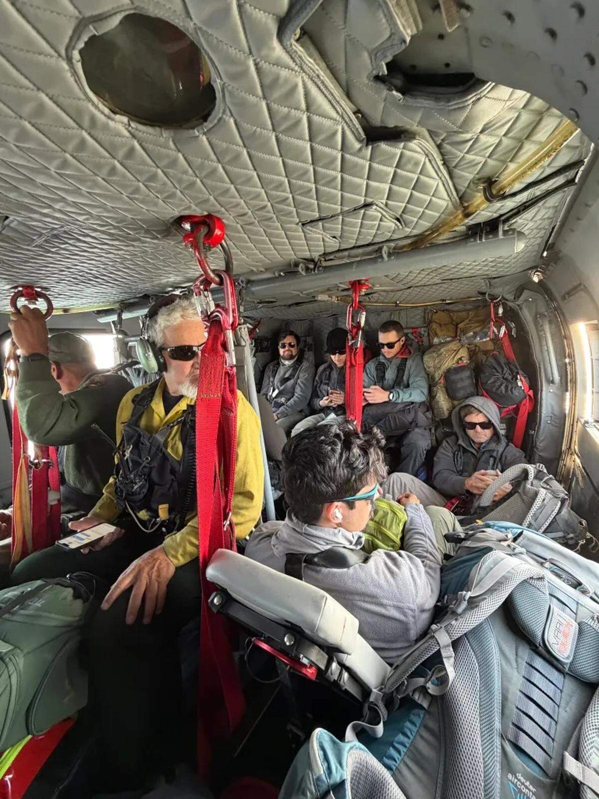 National Park Service employees sit inside Santa Barbara County Copter 964 for their evacuation from Santa Rosa Island due to a fire, on Sunday, May 17, 2026.